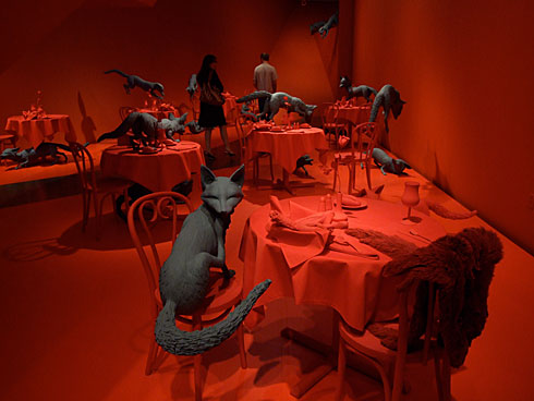 The red tables and grey foxes of Fox Games by Sandy Skoglund