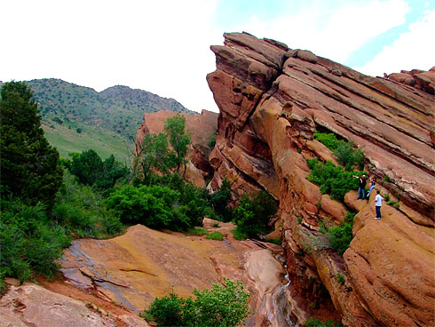 People atop a huge red sandstone formation